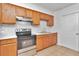 A traditional-style kitchen featuring wood cabinets and stainless steel appliances at 4706 E Sligh Ave, Tampa, FL 33610