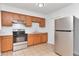 Kitchen featuring wooden cabinets, stainless steel appliances, and white countertops at 4706 E Sligh Ave, Tampa, FL 33610