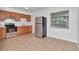 Kitchen featuring wooden cabinets, stainless steel appliances, and neutral tile flooring at 4706 E Sligh Ave, Tampa, FL 33610