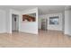 Open-concept living room featuring kitchen view and neutral tile flooring at 4706 E Sligh Ave, Tampa, FL 33610