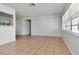 Neutral living area with light tile flooring features ample natural light and neutral paint at 4706 E Sligh Ave, Tampa, FL 33610