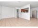 Bright living room with tile floors, open to kitchen, and stainless steel refrigerator at 4706 E Sligh Ave, Tampa, FL 33610