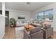 Bright living room is furnished with comfortable seating, neutral decor, and large windows at 4706 E Sligh Ave, Tampa, FL 33610