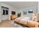 Cozy main bedroom showcasing a modern bed, soft rug, and view to the outside at 4706 E Sligh Ave, Tampa, FL 33610