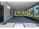 Large screened patio, offering a comfortable outdoor living space, with access to the backyard and natural light at 4706 E Sligh Ave, Tampa, FL 33610