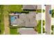Aerial view of the home, highlighting the pool, patio, landscaping, and neighborhood layout at 5026 Bromeliad Ave, Wimauma, FL 33598