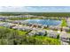 Aerial view of a home within a community, showcasing a lake and serene surroundings at 5026 Bromeliad Ave, Wimauma, FL 33598