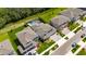 Beautiful aerial view of a home with a pool, a manicured lawn, and a well-maintained landscape at 5026 Bromeliad Ave, Wimauma, FL 33598
