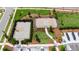 A view from above of a basketball and pickleball court within a fenced park area surrounded by green grass and trees at 5026 Bromeliad Ave, Wimauma, FL 33598
