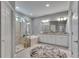 Bright bathroom with a large tub, glass-enclosed shower, granite counters, and soft gray walls at 5026 Bromeliad Ave, Wimauma, FL 33598