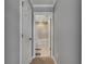 The hallway leads to a bright bathroom with a soaking tub and tiled shower at 5026 Bromeliad Ave, Wimauma, FL 33598