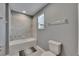 Full bathroom featuring a tub, tile surround, neutral paint, and a single window for natural light at 5026 Bromeliad Ave, Wimauma, FL 33598