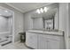 Bathroom vanity with granite countertops, white cabinets, and access to a toilet and bathtub at 5026 Bromeliad Ave, Wimauma, FL 33598