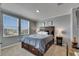 This bedroom features a large window, neutral walls, and a wood-trimmed bed at 5026 Bromeliad Ave, Wimauma, FL 33598