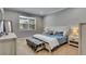 Cozy bedroom with a queen-size bed, soft lighting, and a large window for natural light at 5026 Bromeliad Ave, Wimauma, FL 33598