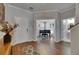 Inviting foyer with wood floors leads to a living area, showcasing home's open design at 5026 Bromeliad Ave, Wimauma, FL 33598