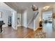 Spacious foyer with hardwood floors, staircase, and views into adjacent living spaces at 5026 Bromeliad Ave, Wimauma, FL 33598