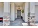Covered front porch with stone columns and elegant hanging lantern provides a warm welcome at 5026 Bromeliad Ave, Wimauma, FL 33598
