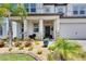 Beautiful home exterior with manicured landscaping, stone accents, and a welcoming front porch at 5026 Bromeliad Ave, Wimauma, FL 33598