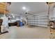 Spacious two-car garage featuring epoxy flooring, storage, and overhead lighting at 5026 Bromeliad Ave, Wimauma, FL 33598