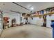 Spacious garage with epoxy floors, shelving, and ample storage space for vehicles and belongings at 5026 Bromeliad Ave, Wimauma, FL 33598