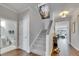 Welcoming hallway with hardwood floors, staircase, and decor with easy access to a powder room at 5026 Bromeliad Ave, Wimauma, FL 33598