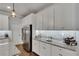 Bright modern kitchen with granite countertops, tile backsplash, stainless appliances, and hardwood floors at 5026 Bromeliad Ave, Wimauma, FL 33598
