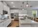 Bright modern kitchen features stainless steel appliances, granite countertops, and an island with bar seating at 5026 Bromeliad Ave, Wimauma, FL 33598