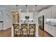 Well-lit kitchen with white cabinets, granite countertops, stainless steel appliances, and central island at 5026 Bromeliad Ave, Wimauma, FL 33598