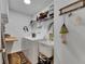 Well-organized laundry room equipped with washer, dryer, utility sink, and ample storage space at 5026 Bromeliad Ave, Wimauma, FL 33598