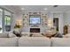 Cozy living room features a large sectional sofa, electric fireplace, and custom built-in shelving at 5026 Bromeliad Ave, Wimauma, FL 33598