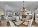 Open-concept living space with modern decor, dining area, and integrated kitchen featuring modern appliances at 5026 Bromeliad Ave, Wimauma, FL 33598