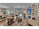 Open-concept living space with large sectional sofa, fireplace, and seamless access to the outdoor pool area at 5026 Bromeliad Ave, Wimauma, FL 33598