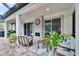 Covered patio with a fireplace and large sliding doors, and outdoor furniture at 5026 Bromeliad Ave, Wimauma, FL 33598