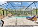 An inviting screened-in pool area offers a peaceful escape with lounge chairs and a stylish outdoor bed at 5026 Bromeliad Ave, Wimauma, FL 33598