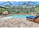 Screened in pool with a patio and many chairs for enjoying the sun and warm weather at 5026 Bromeliad Ave, Wimauma, FL 33598