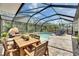 Entertain by the pool at the outdoor dining table at 5026 Bromeliad Ave, Wimauma, FL 33598