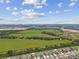Expansive aerial view showcasing the vast green spaces and modern infrastructure, complemented by clusters of homes and roadways at 5410 Amaryllis Garden St, Apollo Beach, FL 33572