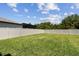 Expansive, well-maintained backyard with a green lawn and privacy fence, perfect for outdoor activities and relaxation at 5410 Amaryllis Garden St, Apollo Beach, FL 33572