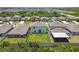 Aerial view of backyard featuring a well-maintained lawn, privacy fence, and covered patio, creating an ideal outdoor living space at 5410 Amaryllis Garden St, Apollo Beach, FL 33572