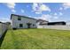 Large, fenced backyard with a well-kept lawn, offering plenty of room for outdoor enjoyment and potential landscaping projects at 5410 Amaryllis Garden St, Apollo Beach, FL 33572