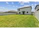 Generous backyard space with a pristine lawn, enclosed by a fence, ideal for Gathering gatherings and outdoor entertainment at 5410 Amaryllis Garden St, Apollo Beach, FL 33572