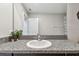 Bathroom vanity features a gray granite countertop, modern faucet, and stylish decorative plant at 5410 Amaryllis Garden St, Apollo Beach, FL 33572