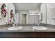 Bathroom with double sinks, granite countertops, and modern fixtures offers a luxurious space at 5410 Amaryllis Garden St, Apollo Beach, FL 33572