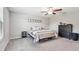 Bedroom features a ceiling fan, carpet flooring, and simple decor at 5410 Amaryllis Garden St, Apollo Beach, FL 33572