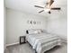 Cozy bedroom with a ceiling fan, moon phase decoration, and comfortable bedding at 5410 Amaryllis Garden St, Apollo Beach, FL 33572