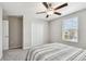Neutral bedroom with carpet, closet, ceiling fan, and plenty of natural light from a large window at 5410 Amaryllis Garden St, Apollo Beach, FL 33572