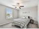 Cozy bedroom featuring a ceiling fan, natural light, and stylish decor at 5410 Amaryllis Garden St, Apollo Beach, FL 33572