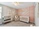 Charming Bedroom with a crib, changing table, and soft decor creates a cozy environment for baby at 5410 Amaryllis Garden St, Apollo Beach, FL 33572
