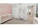 Well-lit Bedroom features a stylish crib, complementing the soft decor and creating a soothing space at 5410 Amaryllis Garden St, Apollo Beach, FL 33572